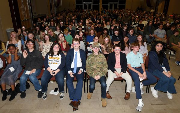 Students wearing 3D glasses sit in the lecture hall