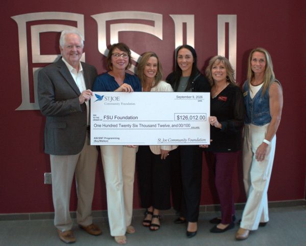 St. Joe presents grant check to ascent program