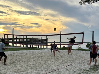 students playing beach volleyball