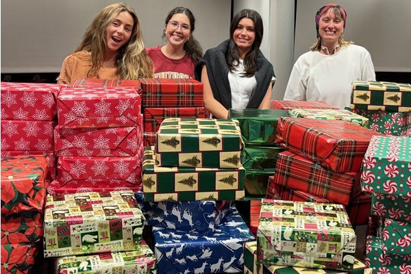Communication Club students with wrapped gifts