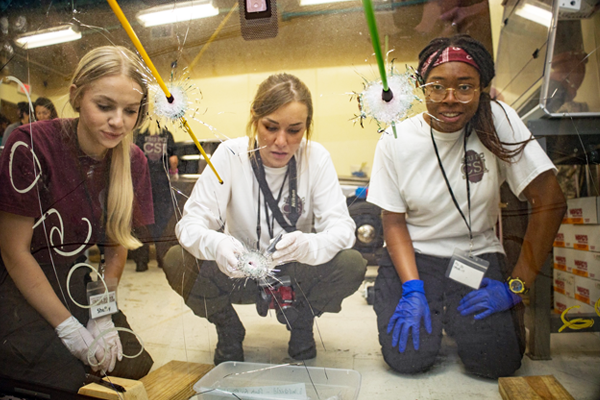 students measure bullet's trajectory through materials