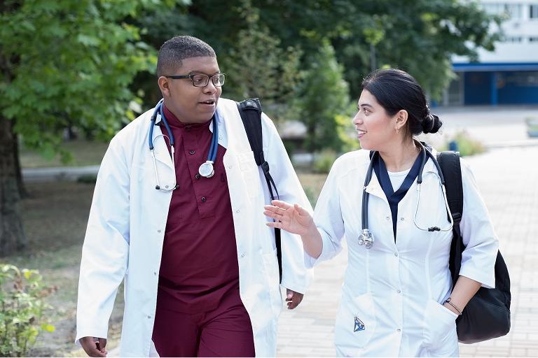 Two student doctors walking together to lab class