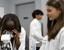 students looking through microscope