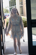 Lady arriving at Holley glass doors 2