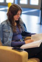 Female student reading in Holley atrium