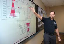 Male SE faculty at smart board in classroom