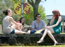 Mixed-gender students sitting on amphitheater wall