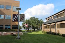 Greenway between the Holley Academic Center and Office buildings with FSU flags