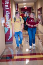 Students walking down hallway in Holley