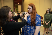 Bay County Sherriff Lt. Koren Colbert pins President Chandra Cooper