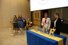 Students light DDE candles, White is Truth, Blue is Justice and Gold is Science