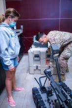 Airman Keith Vici demonstrates bomb robot