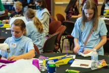 Group table activity, each group receives a plastic bag with the same items to build a raft. Groups are challenged to be able to place at least 50 pennies on the float before it sinks. Participants are encouraged to test their designs, regroup, retest, all a process of engineering.