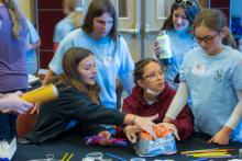 Group table activity, each group receives a plastic bag with the same items to build a raft. Groups are challenged to be able to place at least 50 pennies on the float before it sinks. Participants are encouraged to test their designs, regroup, retest, all a process of engineering.