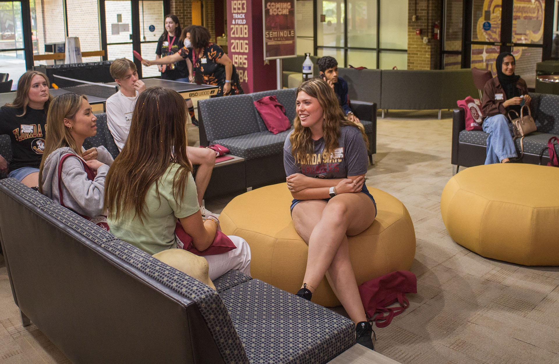 Stents in a social gathering area with couches, bean bags, and table tennis