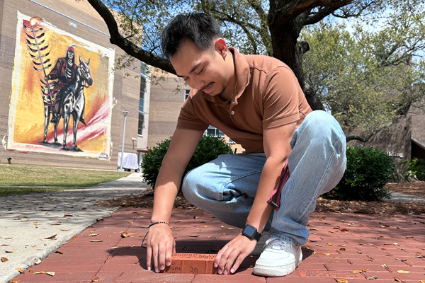 student laying brick