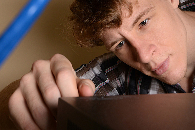student looking closely at object