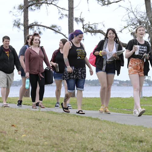 A group of students walking along the North Bay sidewalk to an event