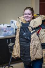 Student tries on 80 lb bomb suit