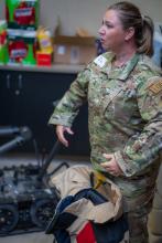 Senior Master Sergeant Lindsay Rickert demonstrates 80 lb bomb suit