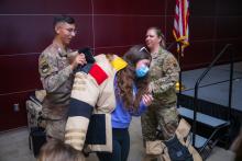 Senior Master Sergeant Lindsay Rickert and Airman Keith Vici help student get into 80 lb bomb suit