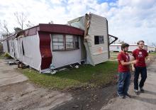 Students carry supplies to trailer home affected by Hurricane Michael
