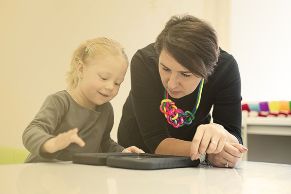 specialist assessing young child in office