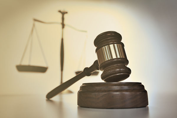 gavel with scales of justice in background
