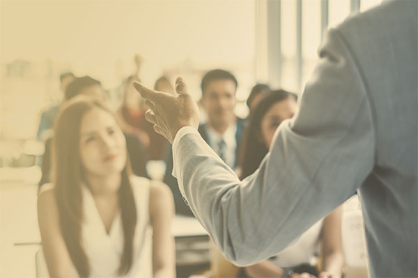 educator presenting to group of professionals