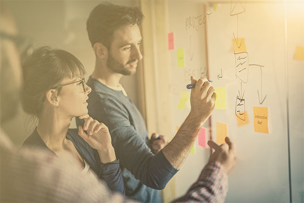 professionals working together at whiteboard