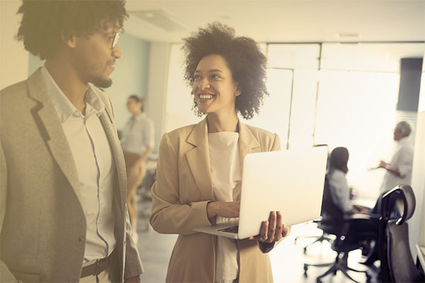 pair of marketing professionals consulting in office