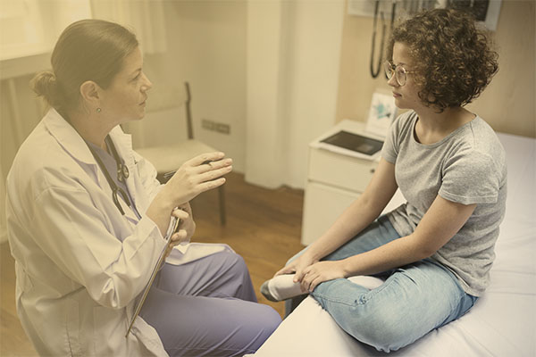 clinician talking with patient in exam room