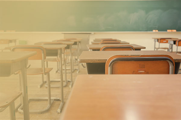 classroom with desks and chalkboard