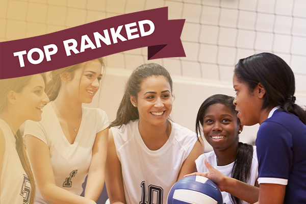 female basketball coach in huddle with team and "top ranked" banner