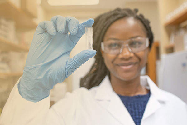 Medical student holding vial.
